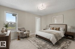 Neutral-toned bedroom featuring a large window, recessed ceiling light fixture, and plush carpeting - 