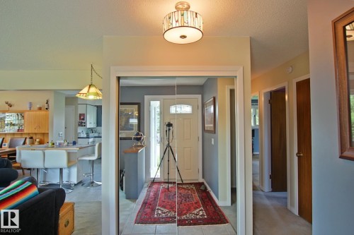 Entryway with a decorative front door featuring a transom window, tile flooring, and a flush mount ceiling light - 3536 104 Street Nw, Edmonton, AB - Indoor Photo Showing Other Room