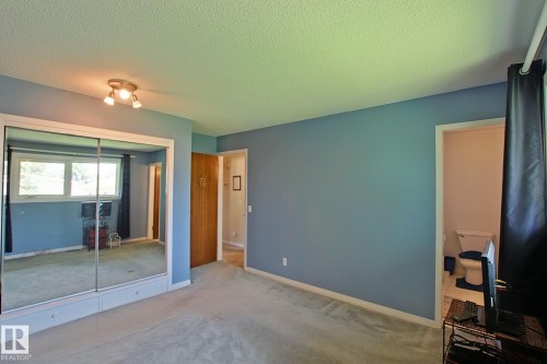 Interior room featuring light blue walls, light-colored carpeting, and white baseboards - 3536 104 Street Nw, Edmonton, AB - Indoor Photo Showing Other Room