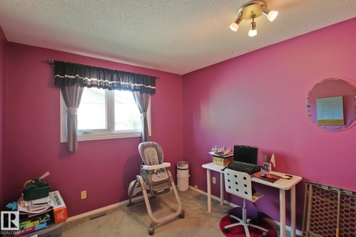 Interior room featuring a single window, track lighting fixture, and carpeted flooring - 3536 104 Street Nw, Edmonton, AB - Indoor