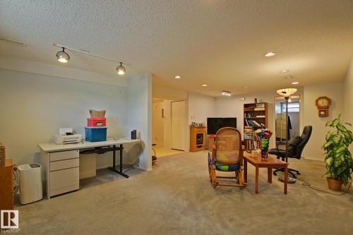 Spacious finished interior with light-toned carpeting and recessed ceiling lighting - 3536 104 Street Nw, Edmonton, AB - Indoor