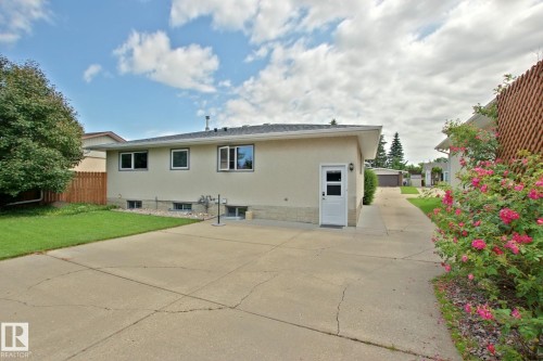 Expansive concrete driveway extending to the rear of the property - 3536 104 Street Nw, Edmonton, AB - Outdoor