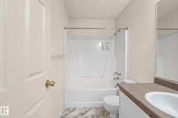 Bathroom featuring a white tub and shower combination with a curved shower rod - 