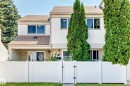 Two-story property featuring light-colored vertical siding and a composite shingle roof - 22 Woodvale Village Nw, Edmonton, AB  - Outdoor 