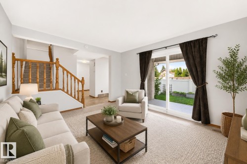 Living area with light-toned walls and carpeted flooring - 22 Woodvale Village Nw, Edmonton, AB - Indoor Photo Showing Living Room