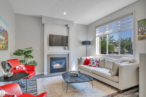 #29 4821 Terwillegar Cm Nw, Edmonton, AB - Indoor Photo Showing Living Room With Fireplace
