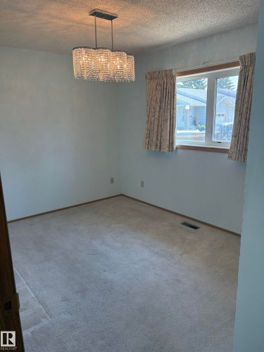 Recessed lighting fixture with crystal embellishments and a rectangular base - 17520 Callingwood Road Nw, Edmonton, AB - Indoor Photo Showing Other Room