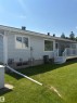 Rear exterior featuring light-colored siding and a multi-level deck with white railings - 17520 Callingwood Road Nw, Edmonton, AB  - Outdoor With Exterior 