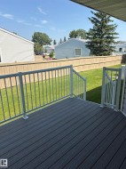 Outdoor deck featuring composite decking and white metal railings - 