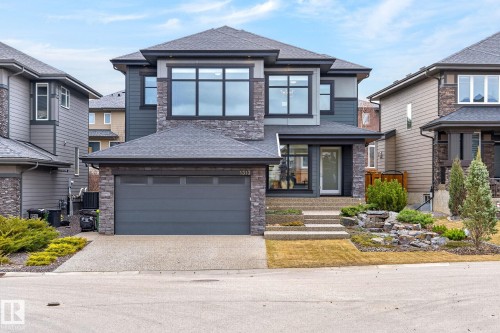 Contemporary two-story residence featuring a stone and siding exterior - 1313 Hainstock Way Sw, Edmonton, AB - Outdoor With Facade