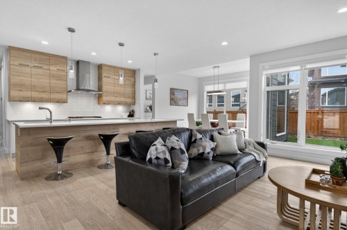 Open-concept living space featuring wood-finish flooring throughout - 1313 Hainstock Way Sw, Edmonton, AB - Indoor Photo Showing Living Room