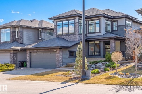 Contemporary two-story residence featuring a stone and siding exterior - 1313 Hainstock Way Sw, Edmonton, AB - Outdoor With Facade