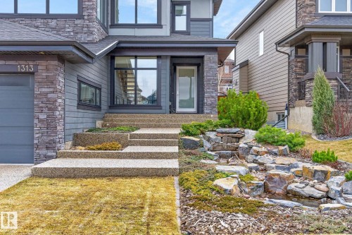 Contemporary exterior featuring stone accents and horizontal siding - 1313 Hainstock Way Sw, Edmonton, AB - Outdoor With Facade
