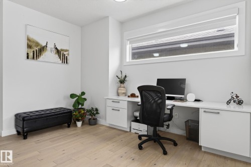 Built-in desk cabinetry with integrated storage - 1313 Hainstock Way Sw, Edmonton, AB - Indoor Photo Showing Office