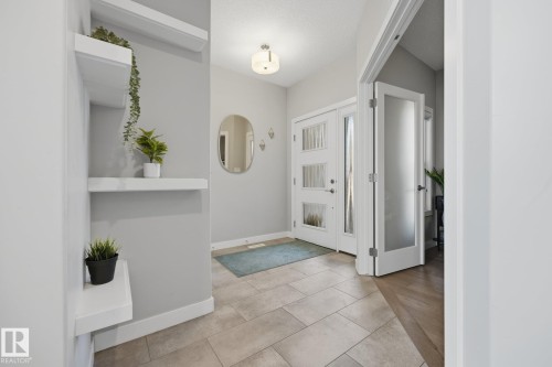 Foyer featuring a white front door with multiple decorative glass panels, recessed lighting, and a neutral tile floor - 3870 Robins Crescent Nw, Edmonton, AB - Indoor Photo Showing Other Room
