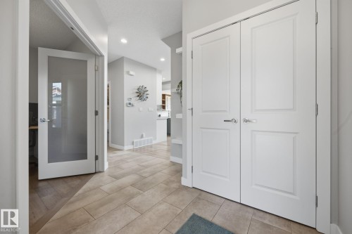 Entryway featuring light-toned tile flooring, recessed lighting, and a frosted glass panel door - 3870 Robins Crescent Nw, Edmonton, AB - Indoor Photo Showing Other Room