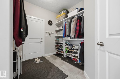 Custom closet organization system featuring built-in shelving and hanging rods - 3870 Robins Crescent Nw, Edmonton, AB - Indoor With Storage