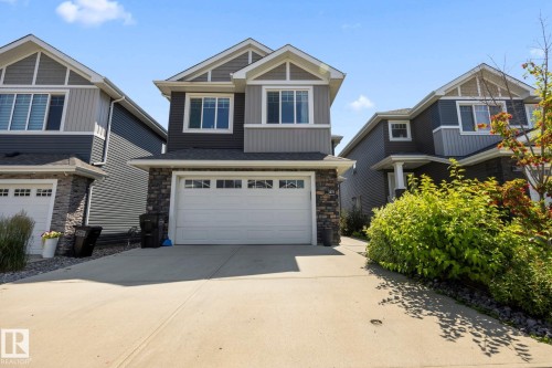 Contemporary two-story exterior with multi-toned siding and stone detailing - 3870 Robins Crescent Nw, Edmonton, AB - Outdoor With Facade