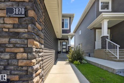 Stone veneer and horizontal siding exterior featuring a covered entry - 3870 Robins Crescent Nw, Edmonton, AB - Outdoor