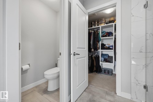 Powder room featuring a sleek white toilet and light grey wall paint - 3870 Robins Crescent Nw, Edmonton, AB - Indoor Photo Showing Bathroom