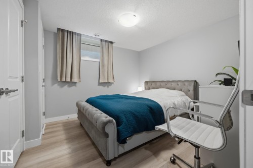 Bedroom featuring light wood-finish flooring, light gray wall paint, and white trim - 3870 Robins Crescent Nw, Edmonton, AB - Indoor Photo Showing Bedroom