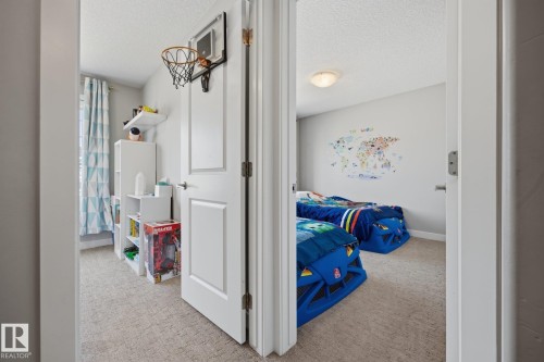 Two distinct rooms featuring neutral-toned carpet flooring and light wall finishes - 3870 Robins Crescent Nw, Edmonton, AB - Indoor Photo Showing Other Room