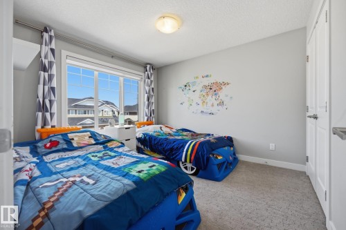 Secondary room with a large window and light gray walls - 3870 Robins Crescent Nw, Edmonton, AB - Indoor Photo Showing Bedroom