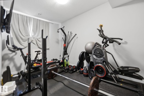 Dedicated fitness room featuring light grey walls, recessed lighting, and a window with light-filtering drapes - 3870 Robins Crescent Nw, Edmonton, AB - Indoor Photo Showing Gym Room