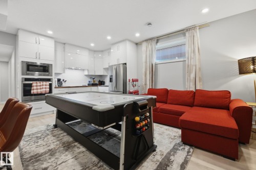 Open-concept living space featuring light wood-finish flooring - 3870 Robins Crescent Nw, Edmonton, AB - Indoor Photo Showing Other Room