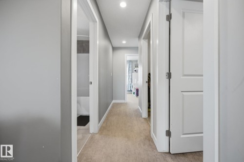 Hallway with light gray walls, recessed lighting, and wood-finish flooring - 3870 Robins Crescent Nw, Edmonton, AB - Indoor Photo Showing Other Room