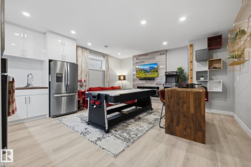 Recreation area featuring wood-finish flooring and recessed lighting - 3870 Robins Crescent Nw, Edmonton, AB - Indoor