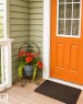 Inviting entry featuring a paneled door with a multi-pane window, light wood-finish porch flooring, white porch railing, and light green horizontal siding - 225 51A Street Sw, Edmonton, AB  - Outdoor With Exterior 