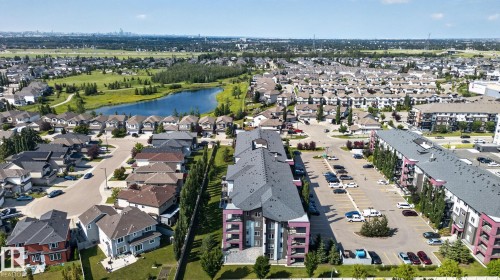 Aerial perspective showcasing a residential community with varied housing styles - #203 5521 7 Av Sw, Edmonton, AB - Outdoor With View