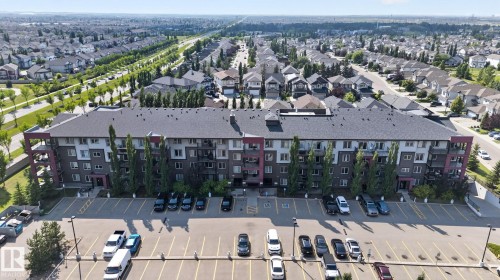 Multi-story building featuring balconies and a dark-toned roof - #203 5521 7 Av Sw, Edmonton, AB - Outdoor With View