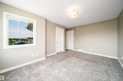Neutral-toned interior room featuring light gray walls, plush gray carpeting, and white trim - 114 James Crescent, St. Albert, AB - Indoor Photo Showing Other Room