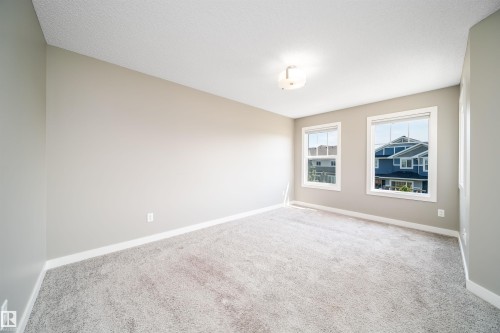 Neutral-toned walls complement plush grey carpeting - 114 James Crescent, St. Albert, AB - Indoor Photo Showing Other Room
