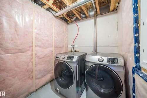 Dedicated laundry area featuring exposed ceiling joists and insulated walls - 114 James Crescent, St. Albert, AB - Indoor Photo Showing Laundry Room