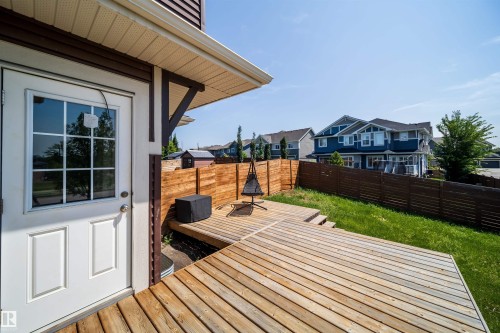 Expansive multi-level wood deck featuring a built-in privacy fence, direct access door, and a grassy yard - 114 James Crescent, St. Albert, AB - Outdoor With Deck Patio Veranda With Exterior