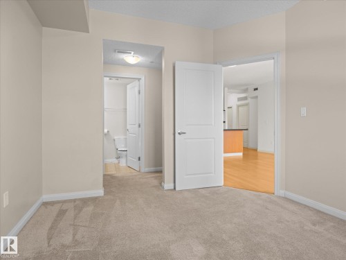 Carpeted room with neutral wall tones - #707 9819 104 St Nw, Edmonton, AB - Indoor Photo Showing Other Room