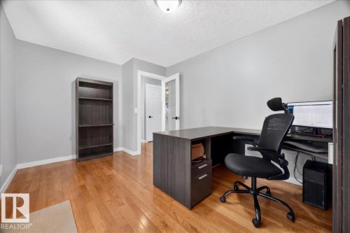 Hardwood flooring throughout this room with gray painted walls and white baseboards - #47 21061 Wye Rd, Rural Strathcona County, AB - Indoor Photo Showing Office