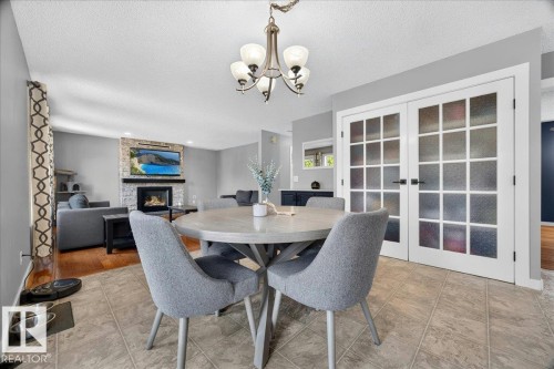White French doors with frosted glass panels - #47 21061 Wye Rd, Rural Strathcona County, AB - Indoor Photo Showing Dining Room