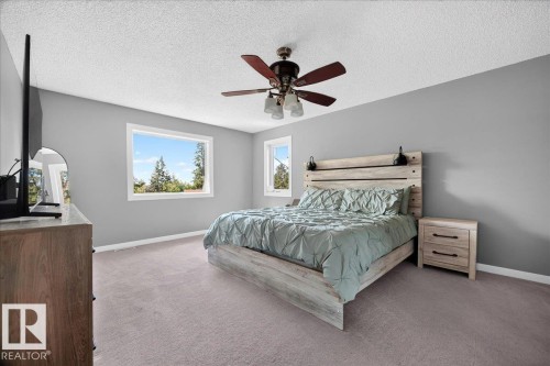 Spacious bedroom featuring light gray walls and plush carpet flooring - #47 21061 Wye Rd, Rural Strathcona County, AB - Indoor Photo Showing Bedroom