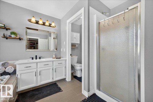 Bathroom vanity featuring white cabinetry, a single sink, and matte black hardware - #47 21061 Wye Rd, Rural Strathcona County, AB - Indoor Photo Showing Bathroom