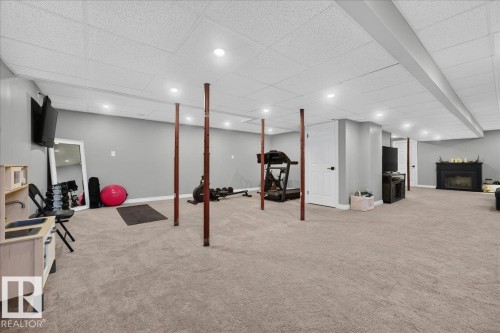 Spacious lower level featuring recessed lighting, light gray wall paint, and neutral carpet flooring - #47 21061 Wye Rd, Rural Strathcona County, AB - Indoor