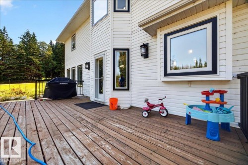 Spacious wood-finish deck with white siding exterior - #47 21061 Wye Rd, Rural Strathcona County, AB - Outdoor With Deck Patio Veranda With Exterior