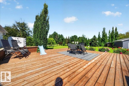 Expansive outdoor deck featuring natural wood-finish planks - #47 21061 Wye Rd, Rural Strathcona County, AB - Outdoor With Deck Patio Veranda With Exterior