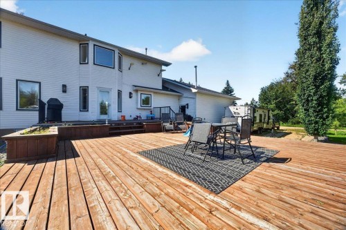 Expansive wooden deck providing substantial outdoor living space - #47 21061 Wye Rd, Rural Strathcona County, AB - Outdoor With Deck Patio Veranda With Exterior