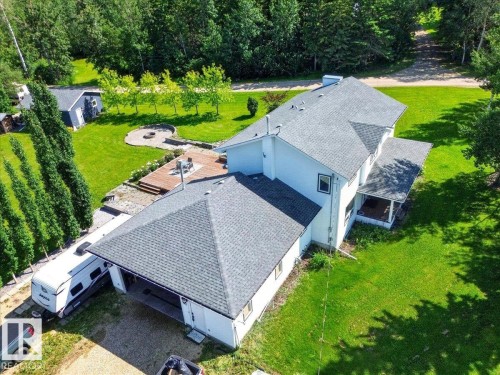 Expansive property featuring a large white residence with a dark gray shingle roof, attached garage, and a covered porch - #47 21061 Wye Rd, Rural Strathcona County, AB - Outdoor