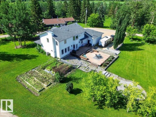 White two-story residence featuring a gray shingle roof and multiple windows - #47 21061 Wye Rd, Rural Strathcona County, AB - Outdoor