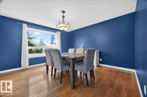 Expansive window offering natural light, highlighting the wood-finish flooring - #47 21061 Wye Rd, Rural Strathcona County, AB - Indoor Photo Showing Dining Room
